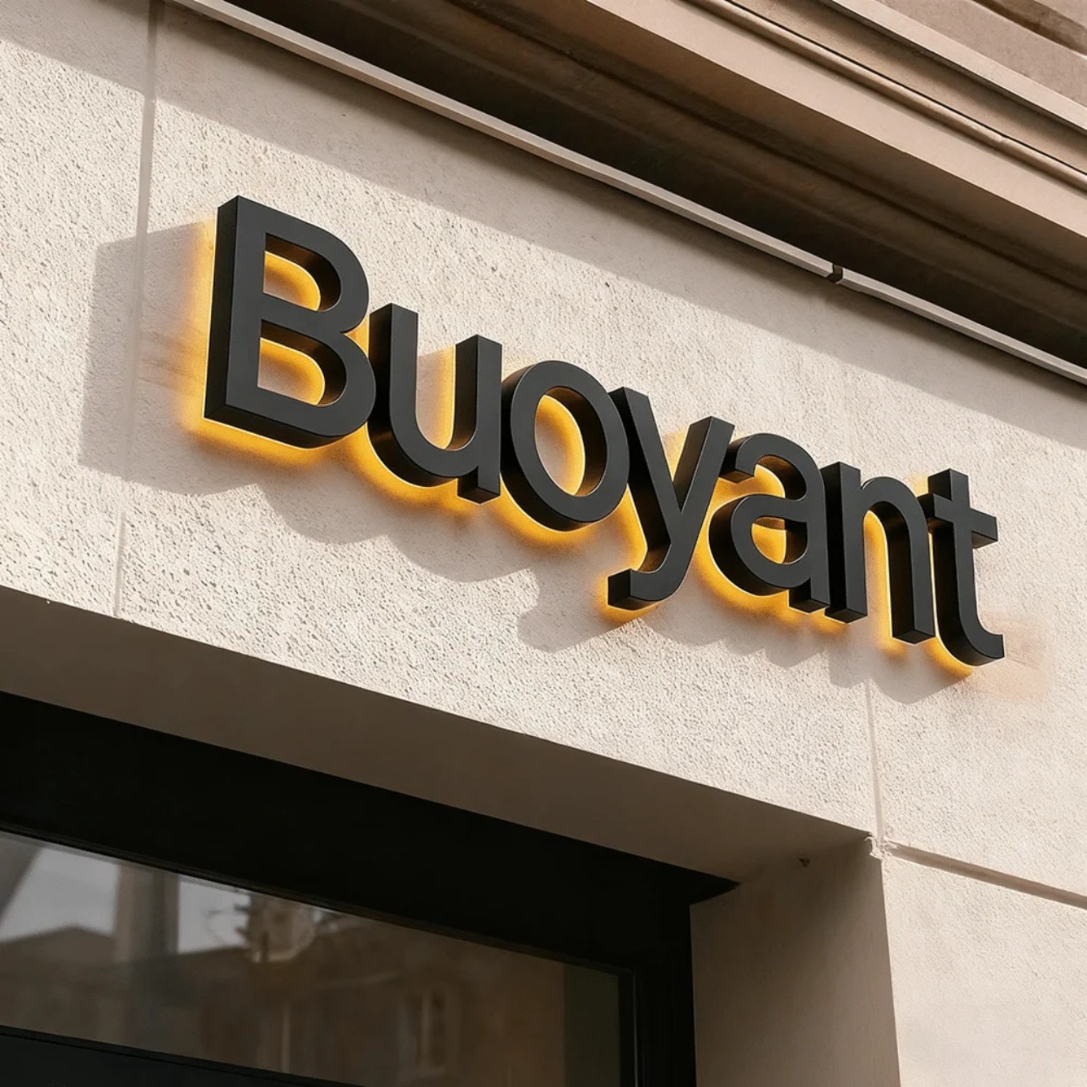 Black dimensional exterior letters with warm amber halo illumination