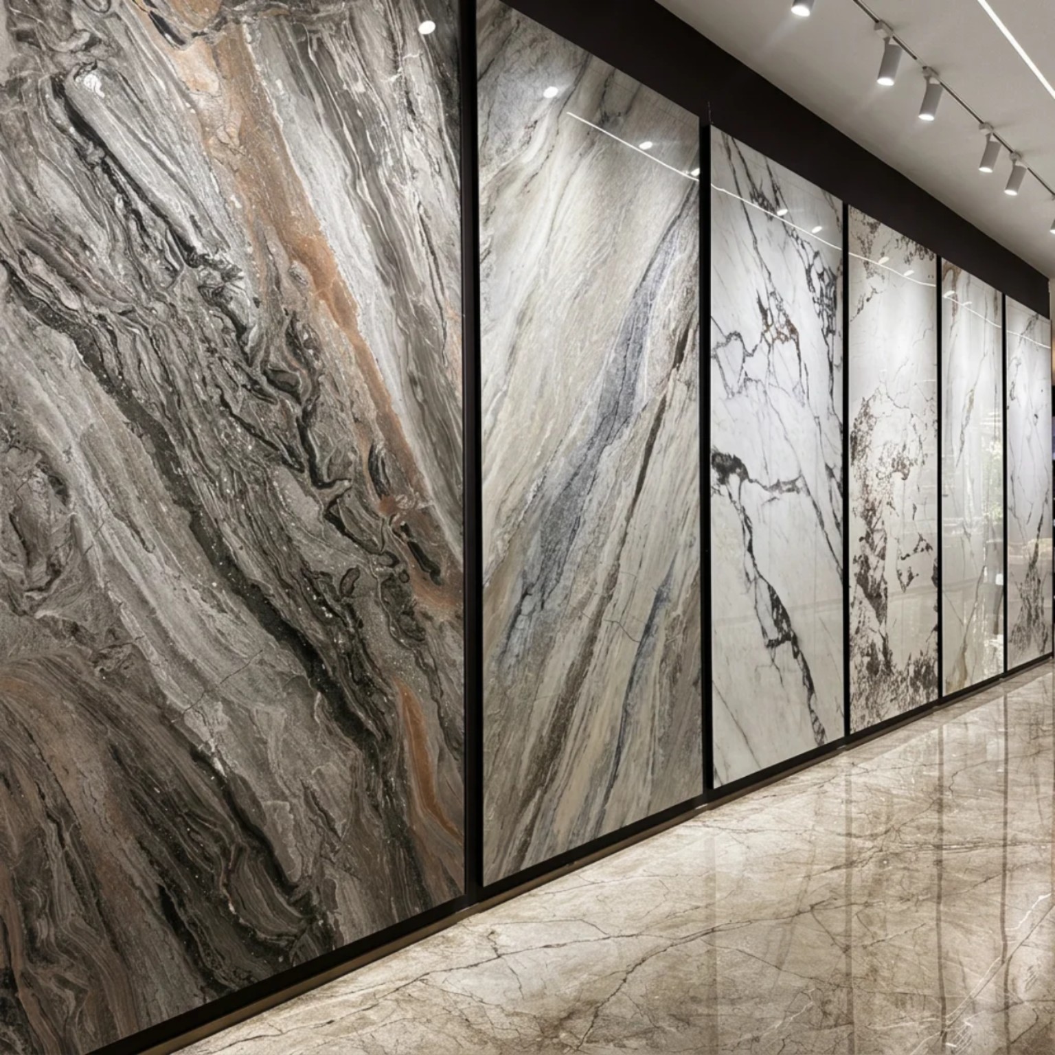 Display wall of large-format marble-look decorative panels in multiple gray and white patterns